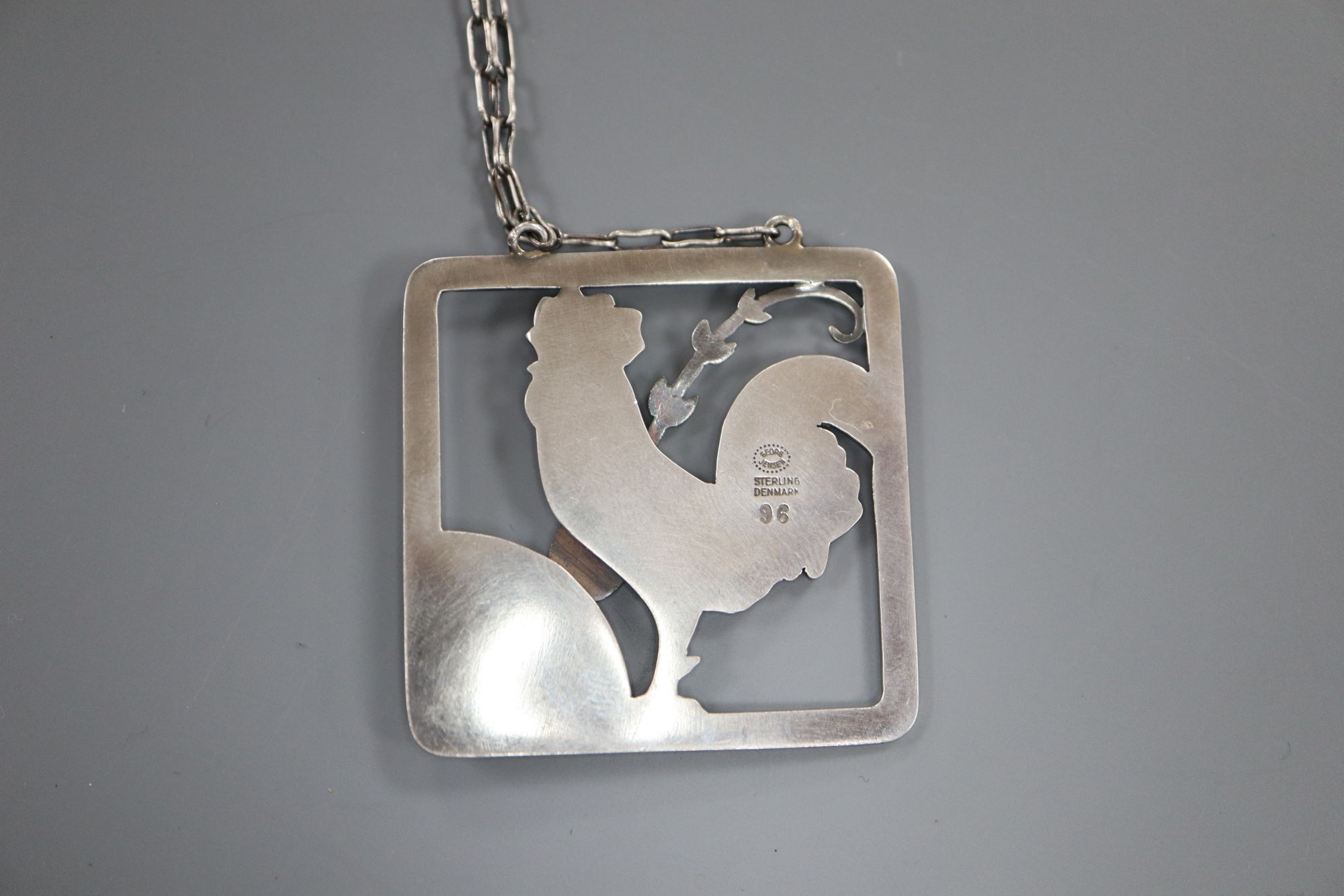 A Georg Jensen sterling Cockerel and foliate spray square pendant on chain, no. 96, pendant 38mm.